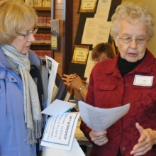 Volunteers explain library programs
